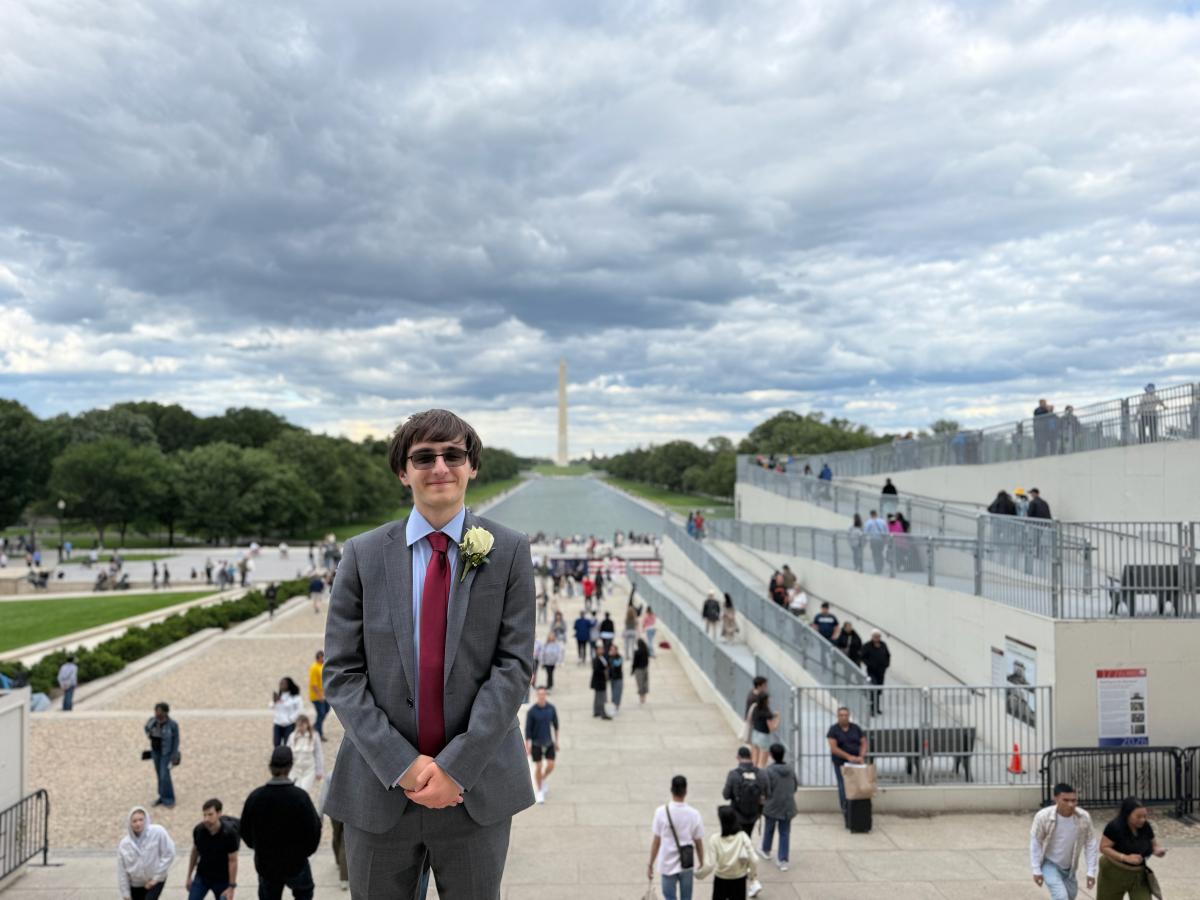 Alexander stands in front of the Washington Monument