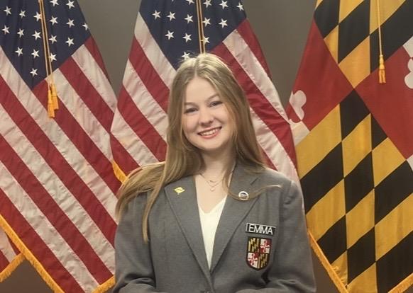 Emma in front of US and Maryland flags