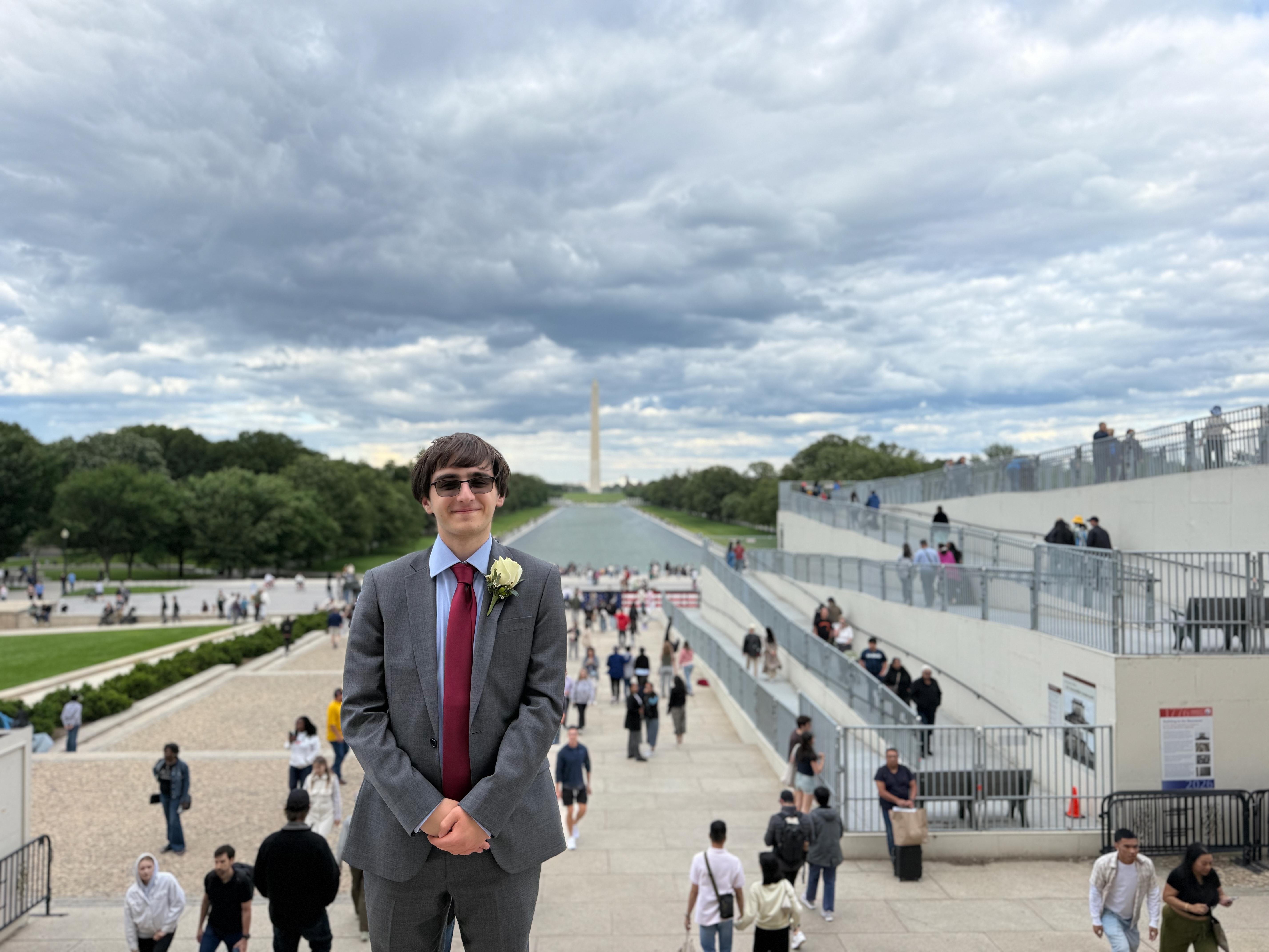 Alexander stands in front of the Washington Monument