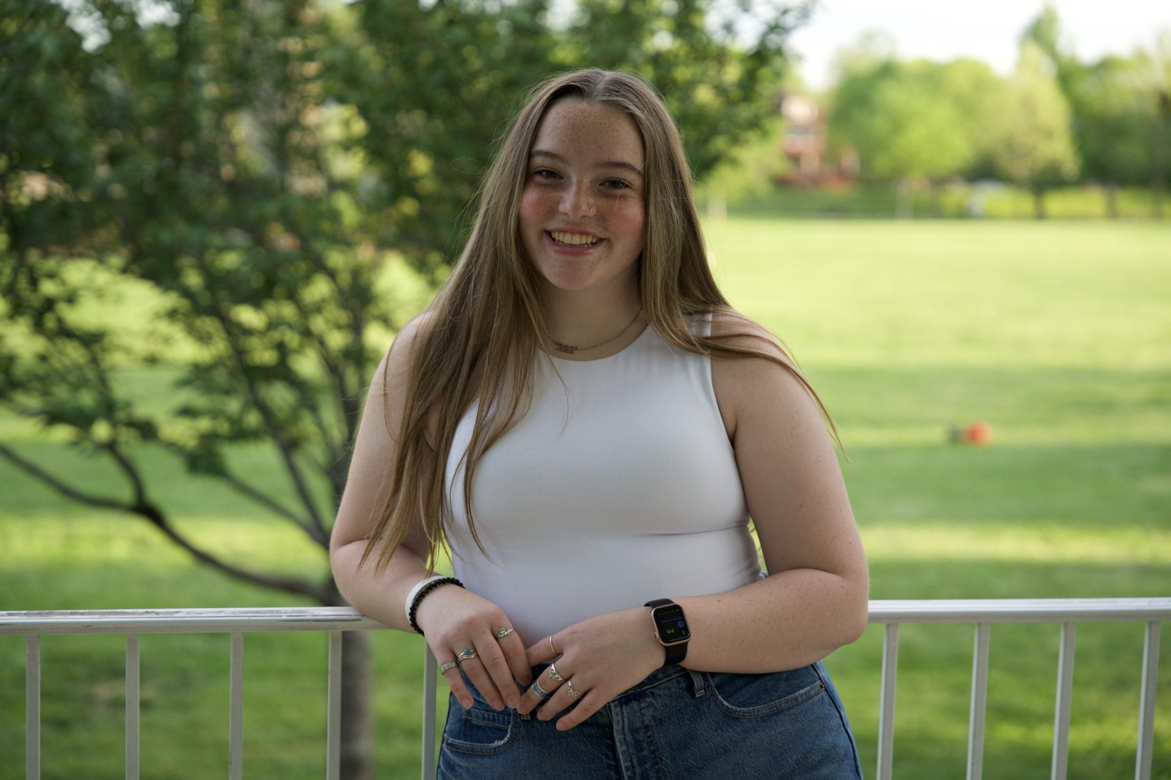 Emily in front of a green meadow